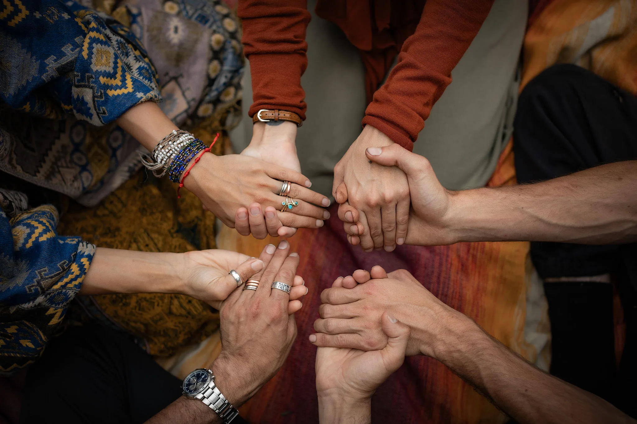 Members of WuWei Village holding hands in community.